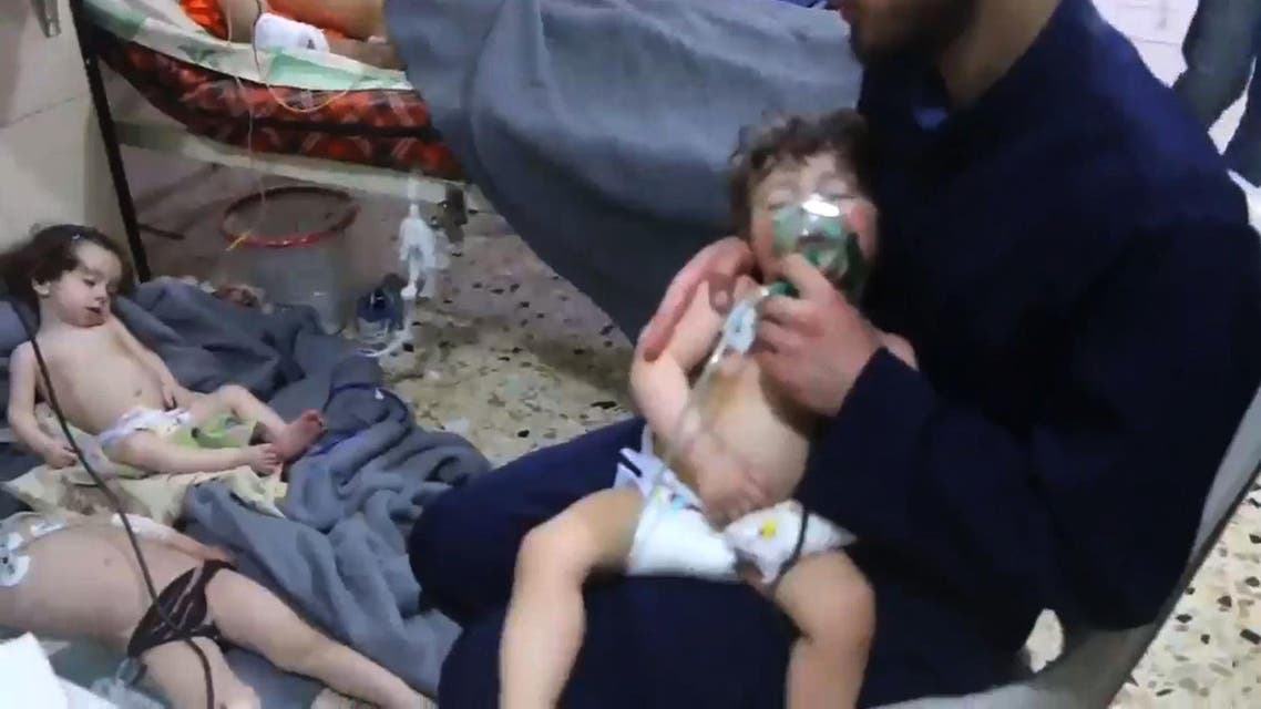 An image grab taken from a video released by the Syrian civil defence in Douma shows unidentified volunteers giving aid to children at a hospital following an alleged chemical attack on the rebel-held town on April 8, 2018. A suspected chemical attack by Syria's regime sparked international outrage, after rescue workers reported dozens killed by poison gas on rebel-held parts of Eastern Ghouta near Damascus. President Bashar al-Assad's regime and its ally Russia denied the allegations of a chlorine gas attack on the town of Douma, calling them "fabrications". HO / AFP / SYRIA CIVIL DEFENCE