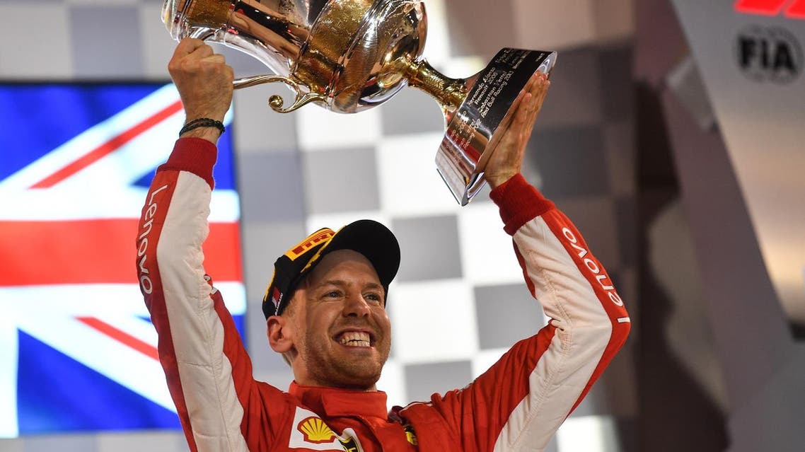 Ferrari’s Sebastian Vettel raises his trophy on the podium after winning the Bahrain Formula One Grand Prix at the Sakhir circuit in Manama on April 8, 2018. (AFP)