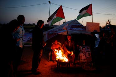 People participate in a symbolic birthday party for Hussein Madi at a tent city protest east of Gaza City on April 9, 2018. (Reuters)