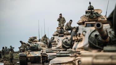 Turkish army tanks gather close to the Syrian border on January 21, 2018 at Hassa, in Hatay province. Turkish forces on January 20, 2018, began a major new operation aimed at ousting the Peoples' Protection Units (YPG) Kurdish militia from Afrin, pounding dozens of targets from the sky in air raids and with artillery. Turkey accuses the YPG of being the Syrian offshoot of the Kurdistan Workers' Party (PKK) which has waged a rebellion in the Turkish southeast for more than three decades and is regarded as a terror group by Ankara and its Western allies.  BULENT KILIC / AFP