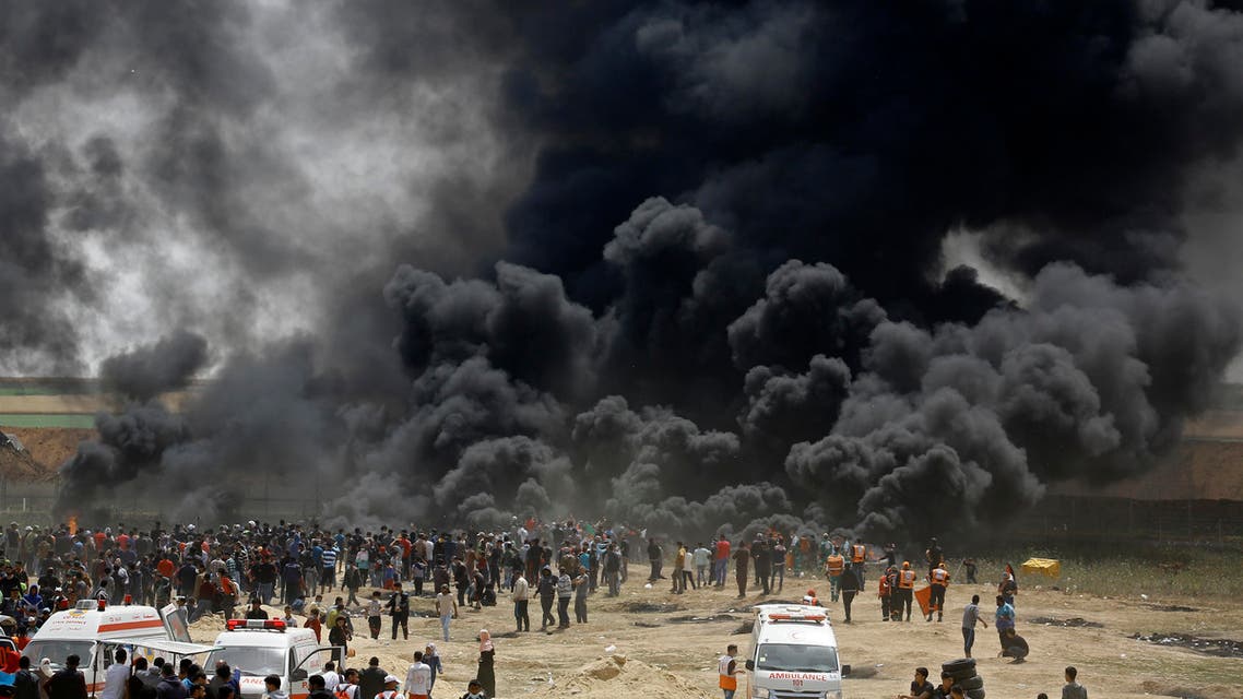 Palestinians burn tires at the border fence with Israel, east of Jabalia in the central Gaza city, during a protest on April 13, 2018. Several thousand Gazans gathered for a third consecutive Friday of mass protests along the border with Israel after violence in which Israeli forces have killed 33 Palestinians and wounded hundreds of others. (AFP)
