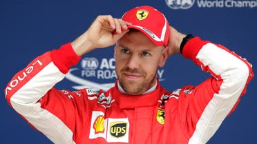 Ferrari driver Sebastian Vettel of Germany puts on his cap after taking pole position for the Chinese Formula One Grand Prix at the Shanghai International Circuit in Shanghai, Saturday, April 14, 2018. (AP Photo/Andy Wong)