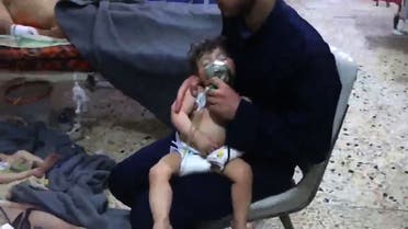 An image grab taken from a video released by the Syrian civil defence in Douma shows unidentified volunteers giving aid to children at a hospital following an alleged chemical attack on the rebel-held town on April 8, 2018. A suspected chemical attack by Syria's regime sparked international outrage, after rescue workers reported dozens killed by poison gas on rebel-held parts of Eastern Ghouta near Damascus. President Bashar al-Assad's regime and its ally Russia denied the allegations of a chlorine gas attack on the town of Douma, calling them "fabrications".   HO / AFP / SYRIA CIVIL DEFENCE