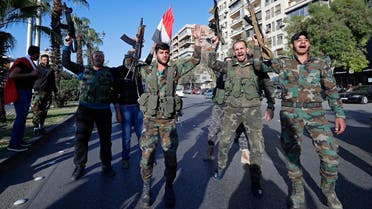 Syrian soldiers chant slogans during demonstrations following a wave of strikes in Damascus, Syria, Saturday, April 14, 2018. (AP)
