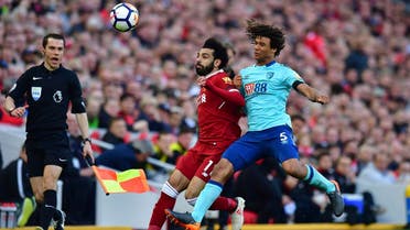 Liverpool’s Mohamed Salah (left), and AFC Bournemouth’s Nathan Ake battle for the ball during the English Premier League soccer match between at Anfield, Liverpool, on April 14, 2018. (AP)