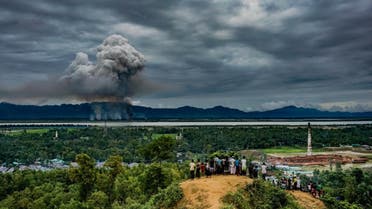 Third-placed image of World Press Photo 2018 contest for General News Singles taken by Md Masfiqur Akhtar Sohan shows a group of Rohingya watch as houses burn across the border in Myanmar on September 9, 2017. (Reuters)