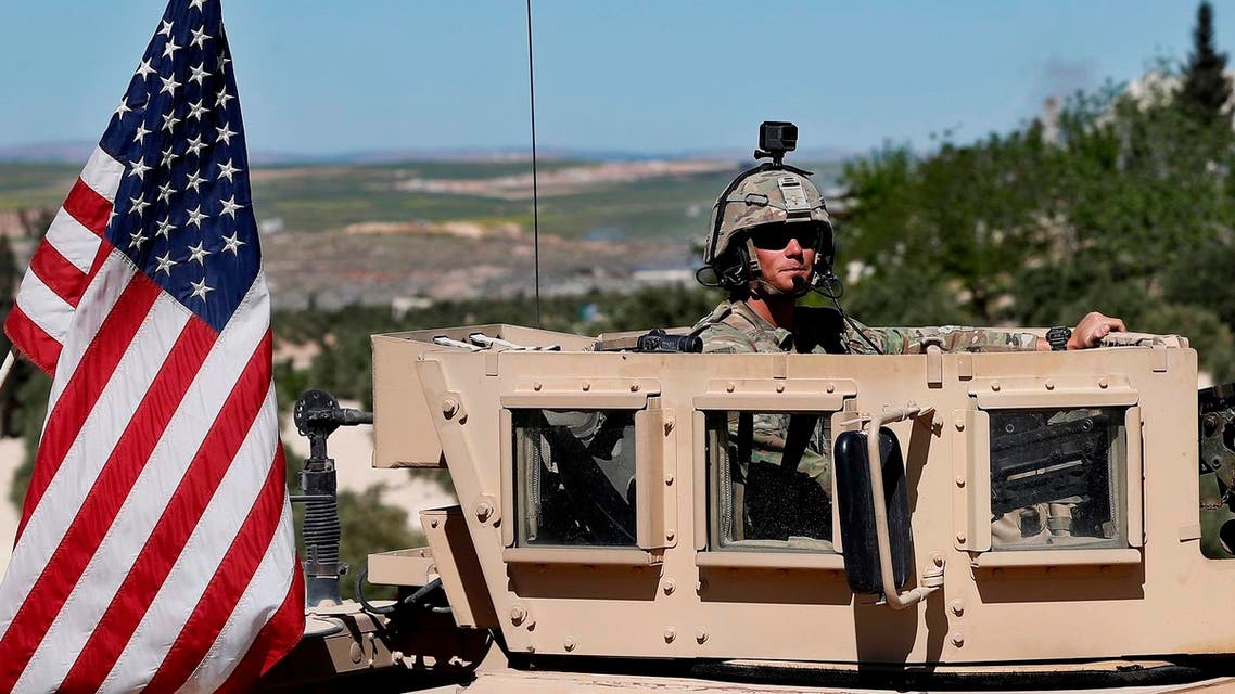 A US soldier sits on his armored vehicle on a road leading to Manbij, north Syria, on April 4, 2018. (AP)