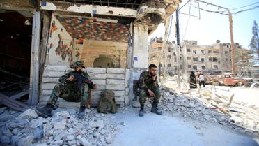 Members of Syrian police sit at a damaged building at the city of Douma, Damascus, Syria April 16, 2018. (Reuters)