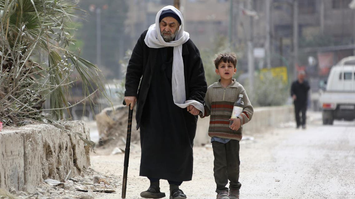 Civilians walk in Douma on the outskirts of Damascus on April 17, 2018. (AFP)