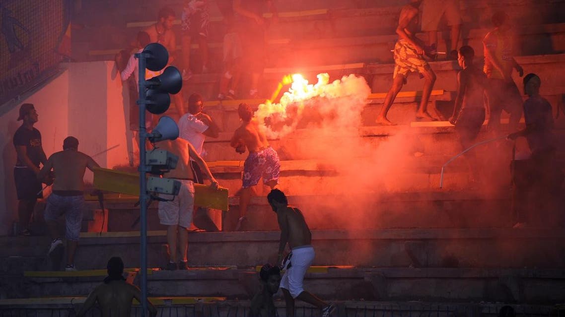 Supporters light a flare during the African Champions League group B football match Esperance de Tunis against MC Alger at El Menzeh Olympic stadium in Tunis. (File photo: AFP)