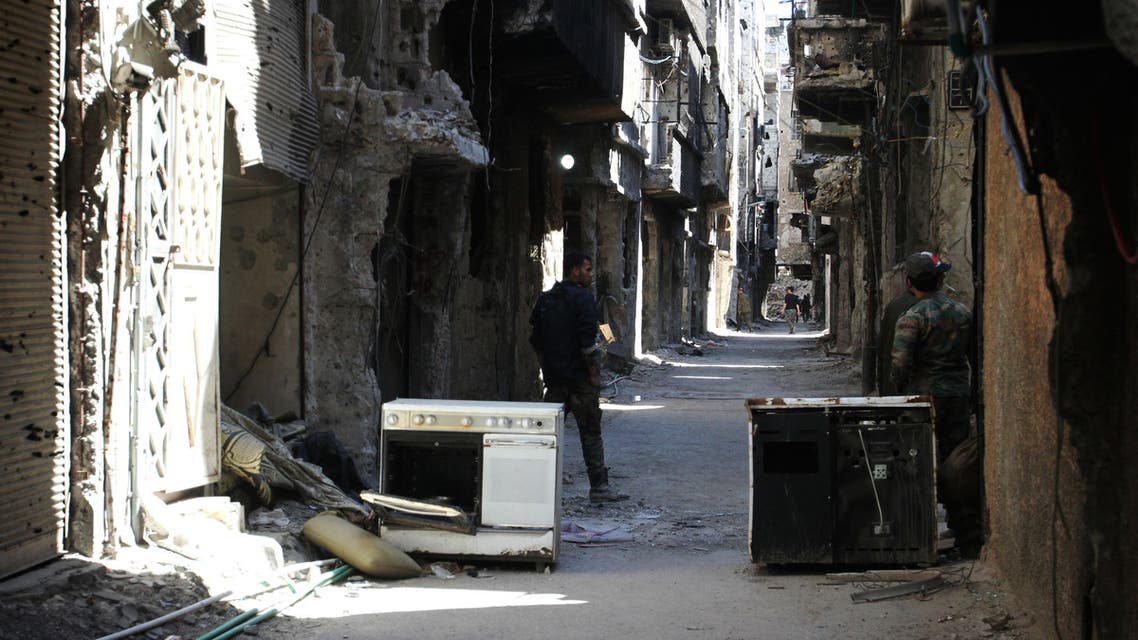 Men stand in an alleyway of demolished buildings in the Yarmuk Palestinian refugee camp in the Syrian capital Damascus on April 6, 2015. Around 2,000 people have been evacuated from the camp after the Islamic State group seized large parts of it. At least 26 people, including civilians as well as fighters from IS and Palestinian factions, had been killed in the camp according to the Syrian Observatory for Human Rights. AFP PHOTO / YOUSSEF KARWASHAN YOUSSEF KARWASHAN / AFP