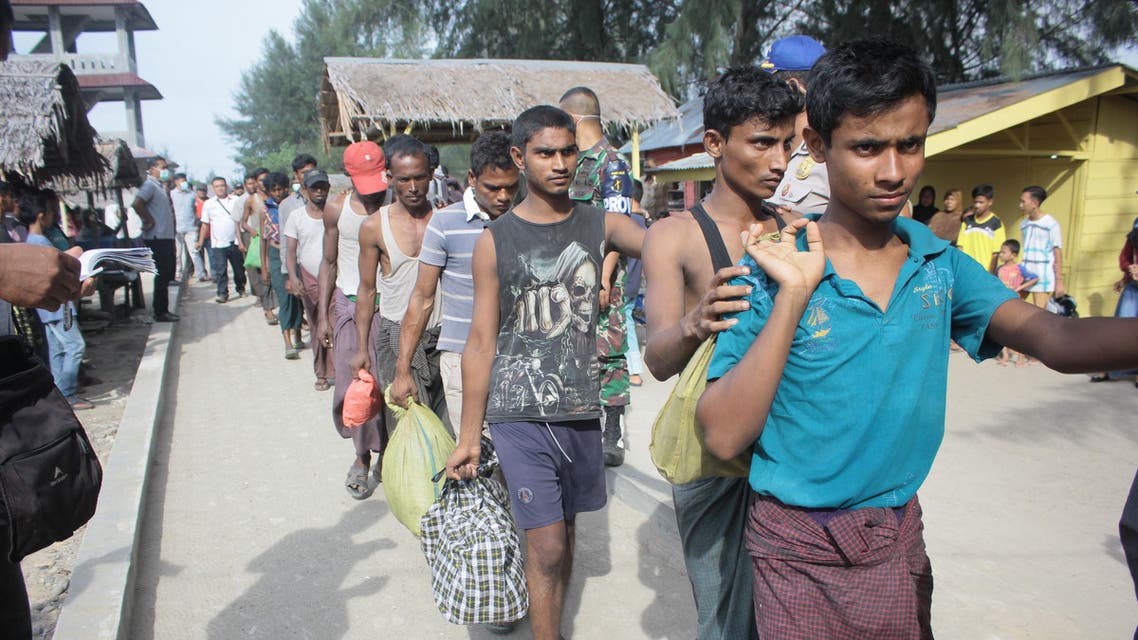A group of Rohingya refugee make their way to a temporary shelter after landing in Aceh province on Sumatra island on April 20, 2018, just weeks after dozens of the persecuted Muslim minority from Myanmar came ashore in neighbouring Malaysia. About 80 Rohingya in a wooden boat arrived in Indonesia on April 20, officials said, the latest batch of the vulnerable minority to come ashore in the world's biggest Muslim majority nation. Amanda JUFRIAN / AFP