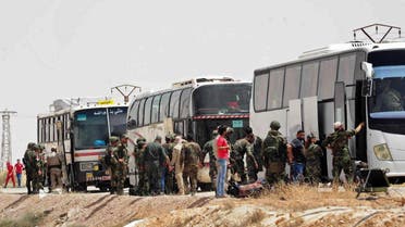 This photo released by the Syrian official news agency SANA, shows Russian soldiers and Syrian government forces overseeing the evacuation of rebel fighters from the Army of Islam and their families from the town of Dumayr, northeast of Damascus, Syria, on April 19, 2018.  (AP)