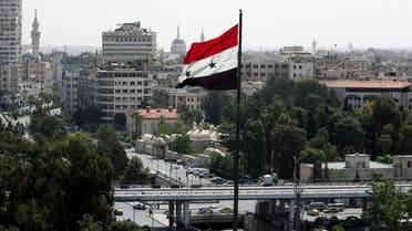 A Syrian flag flutters in Damascus on April 20, 2018. (Reuters)