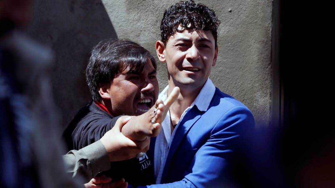 A man reacts as others comfort him at the site of a suicide attack in Kabul on April 22, 2018. (Reuters)