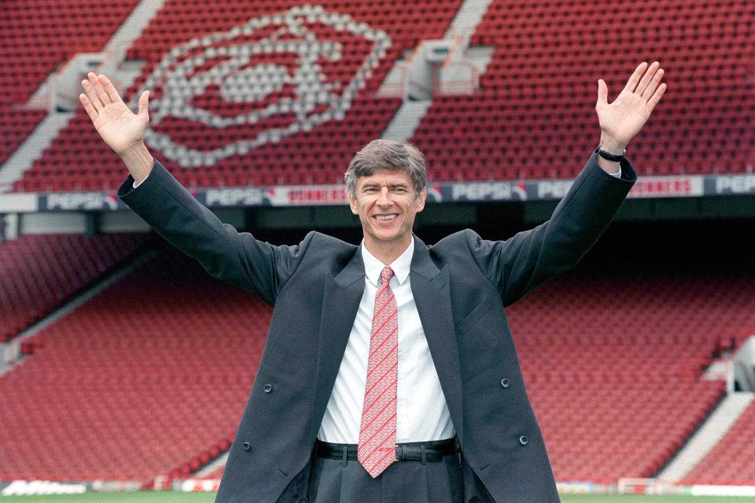 In this Sept. 22, 1996 file photo new Arsenal manager Arsene Wenger gestures following a press conference at Highbury Stadium, London. (AP)