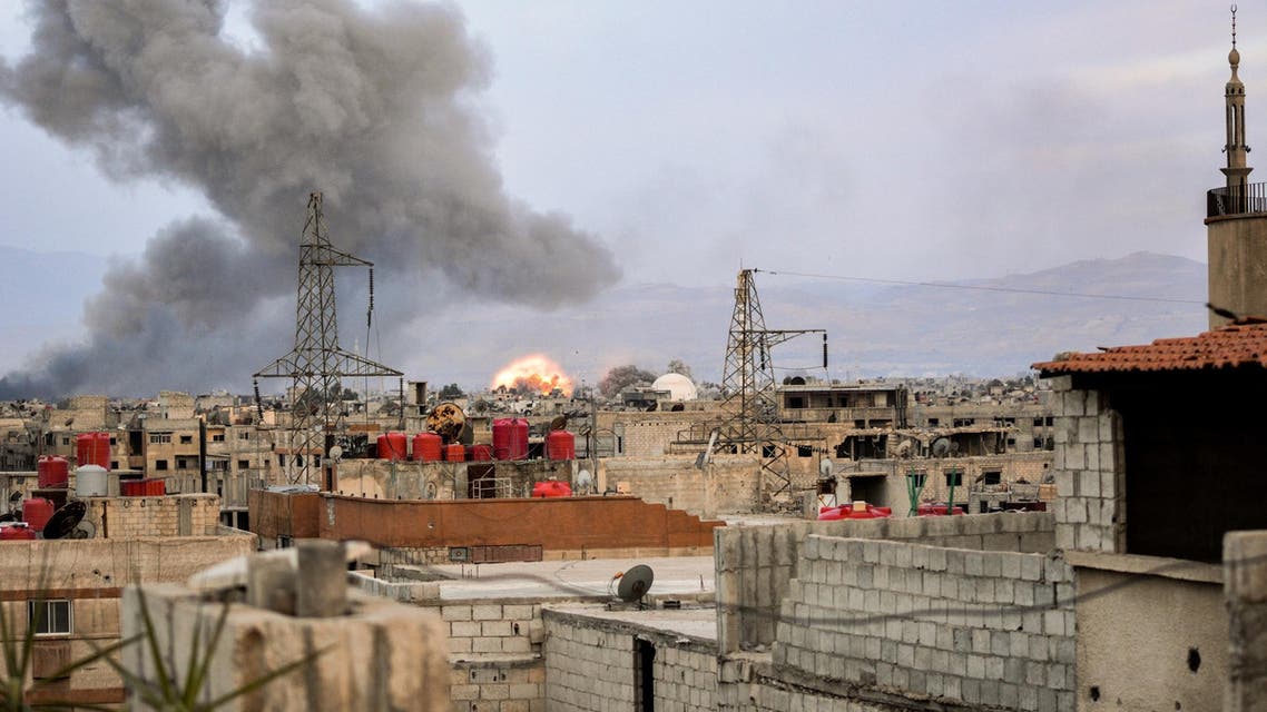 Smoke billows and an explosion erupts in a southern district of Damascus during regime strikes targeting ISIS in Yarmouk. (AF)