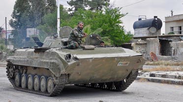 Syrian government soldiers drive an armored personal vehicle in Al Ḩajar al Aswad, on April 22, 2018, during a regime offensive targeting ISIS in the southern districts of Damascus. (AFP)