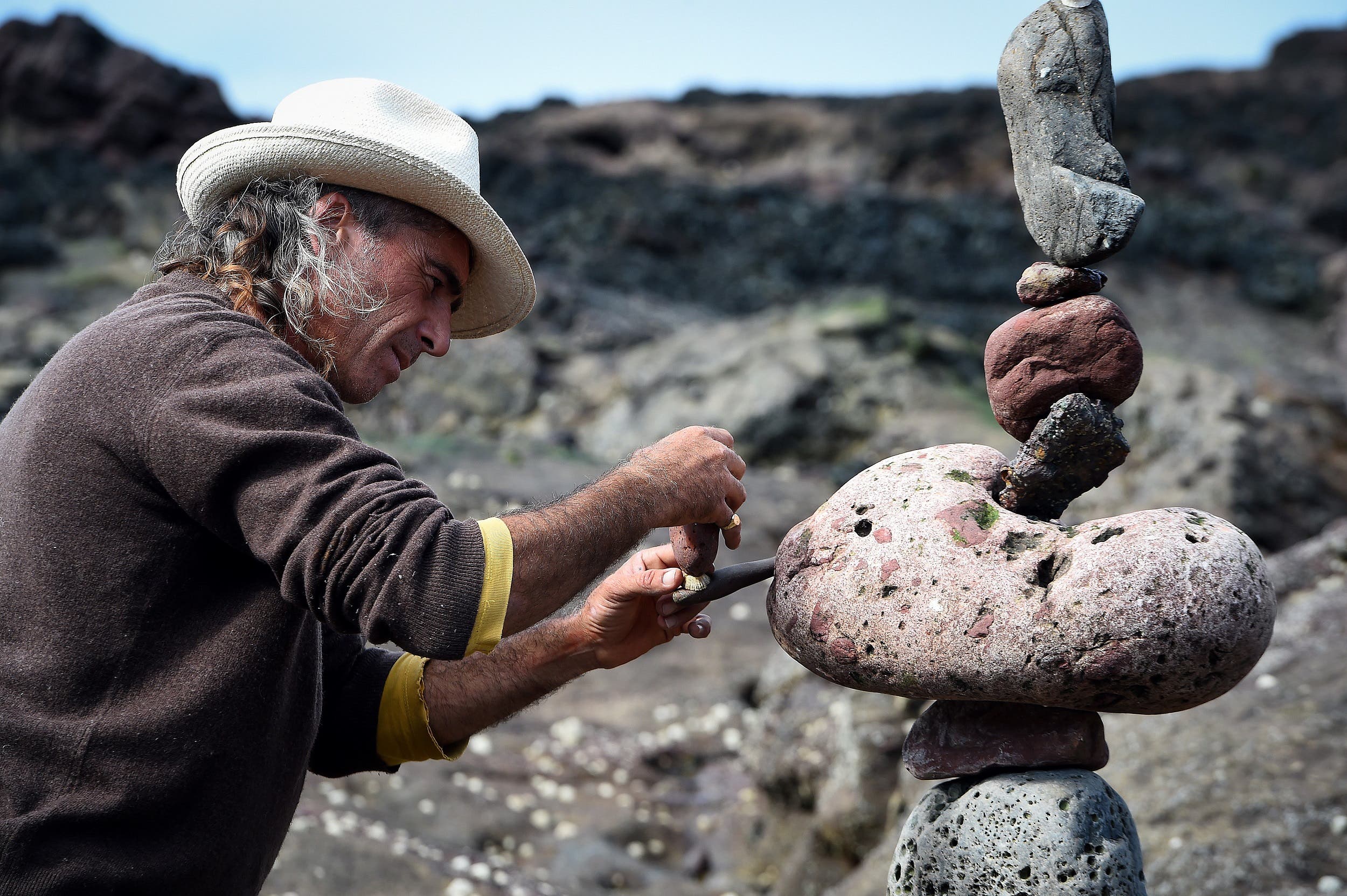 Marco Montesini from Spain competes in the European Stone Stacking Championships 2018 in Dunbar on April 22, 2018. (AFP)