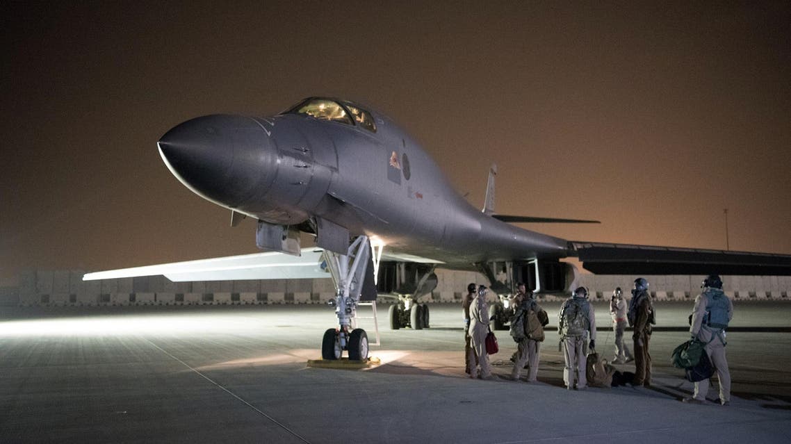 Airmen with the 379th Expeditionary Maintenance Group perform preflight checks on a 34th Bomb Squadron B-1B Lancer aircraft at al-Udeid Air Base in Qatar on April 13, 2018. (AFP)
