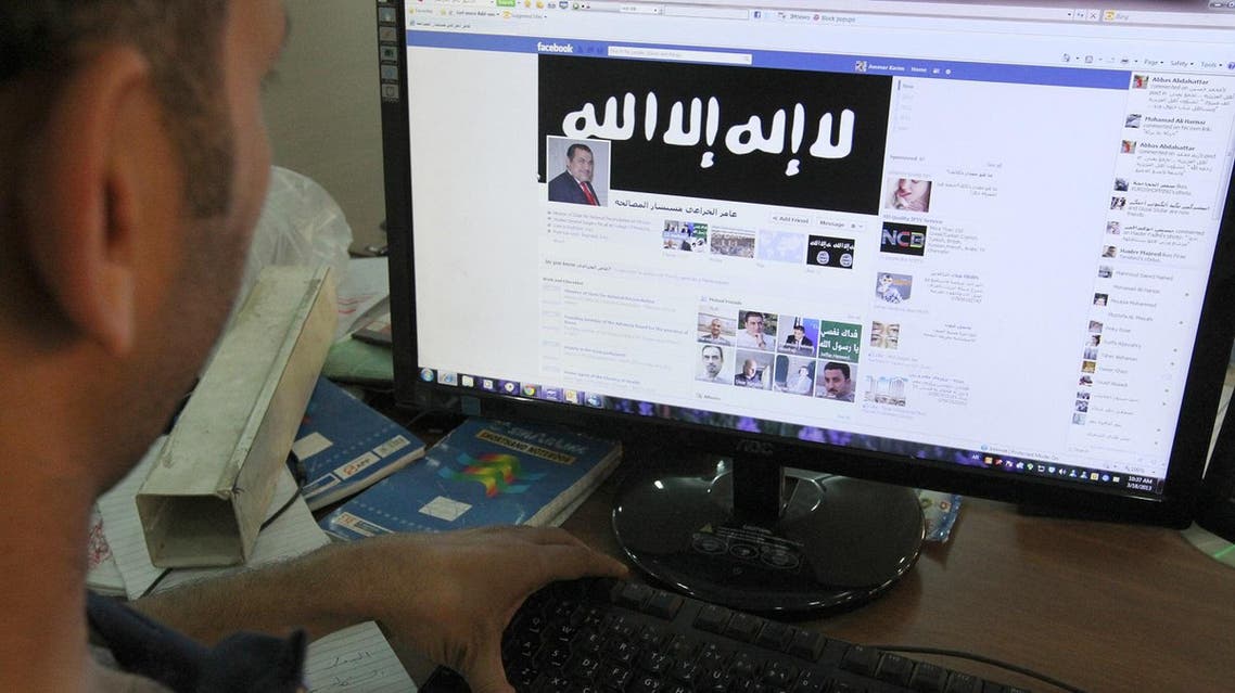 An Iraqi man looks at a Facebook page, hacked by a local group allegedly linked to al-Qaeda on March 18, 2013, in Baghdad. (File photo: AFP)