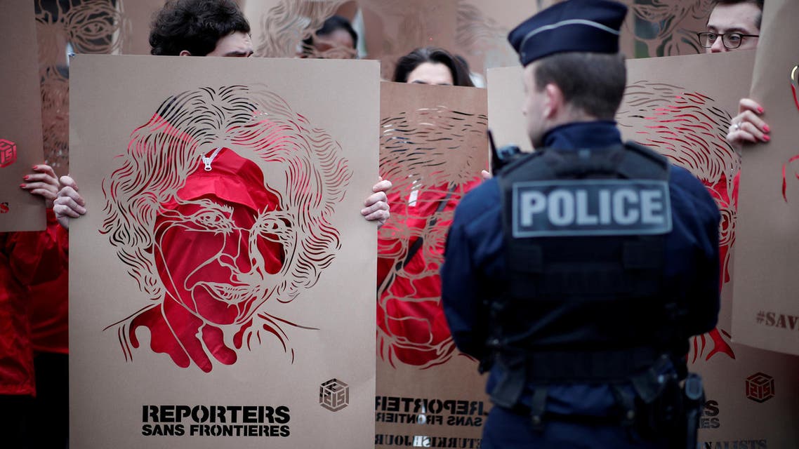 Members of Reporters Without Borders (RSF) hold stencils made by French street artist C215 representing portraits of emprisonned Turkish journalists, as they take part in a demonstration in front of the Turkish embassy in Paris, France, January 5, 2018. (Reuters)