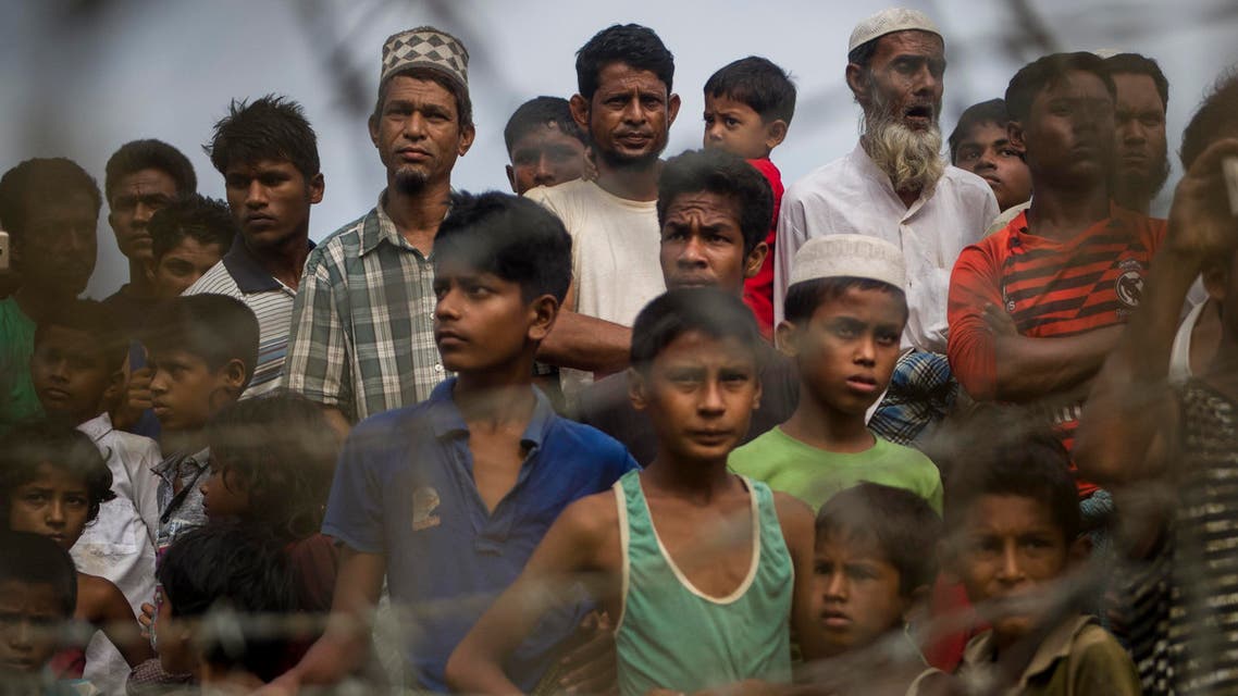 Rohingya refugees gather in the "no man's land" behind Myanmar's boder lined with barb wire fences in Maungdaw district, Rakhine state bounded by Bangladesh on April 25, 2018. Myanmar government said on April 15, it repatriated on April 14 the first family of Rohingya out of some 700,000 refugees who have fled a brutal military campaign, a move slammed by a rights group as a PR stunt ignoring UN warnings that a safe return is not yet possible. (AFP)