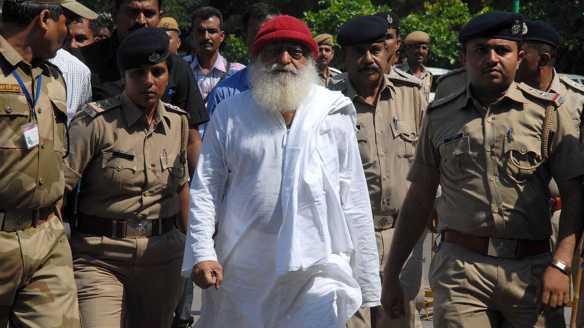 Asaram Bapu (C) is escorted by police in Jodhpur on October 14, 2013. (AFP)