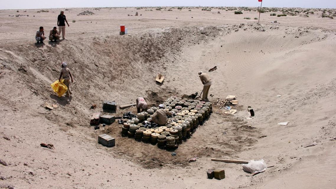Members of a Yemeni military demining unit prepare to destroy unexploded bombs and mines collected from conflict areas near the southern port city of Aden. (Reuters)