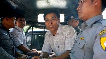 Detained Reuters journalist Kyaw Soe Oo and Wa Lone are transported in a police vehicle after a court hearing in Yangon, Myanmar April 20, 2018 . REUTERS/Ann Wang