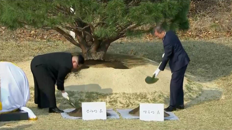 South Korean President Moon Jae-in and North Korean leader Kim Jong Un attend tree planting ceremony during the inter-Korean summit at the truce village of Panmunjom, in this still frame taken from video, South Korea April 27, 2018. Host Broadcaster via REUTERS TV