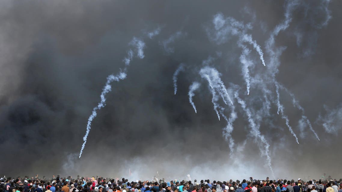 Tear gas canisters are fired by Israeli troops at Palestinian demonstrators during clashes at a protest demanding the right to return to their homeland, at the Israel-Gaza border in the southern Gaza Strip, April 27, 2018. REUTERS/Ibraheem Abu Mustafa TPX IMAGES OF THE DAY