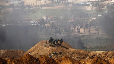 Israeli soldiers are seen next to the border fence on the Israeli side of the Israel-Gaza border. (Reuters)