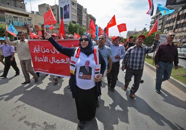 Supporter of the Iraqi Communist Party hold the communist symbol of the hammer and sickle during a march celebrating the International Labour Day in the Iraqi capital Baghdad. (AFP)