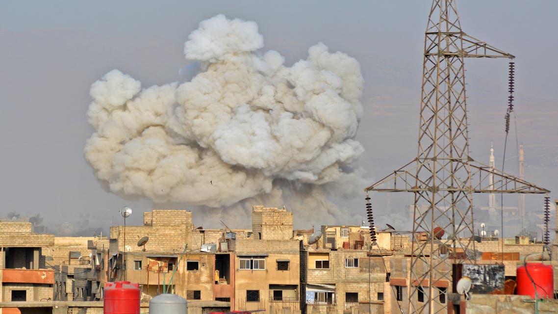 A general view shows smoke rising from buildings during regime strikes on the Palestinian camp of Yarmuk and the neighbouring al-Hajar al-Aswad district, in southern Damascus, on May 1, 2018. A deal has been reached for the evacuation of the Palestinian refugee camp of Yarmuk where Islamic State group fighters have been holed up in southern Damascus, state media reported. Rami al SAYED / AFP