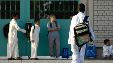 Saudi schoolboys wait for the bus in front of their school as Saudi schools start the first day in the eastern city of Dammam. (File photo: AFP)
