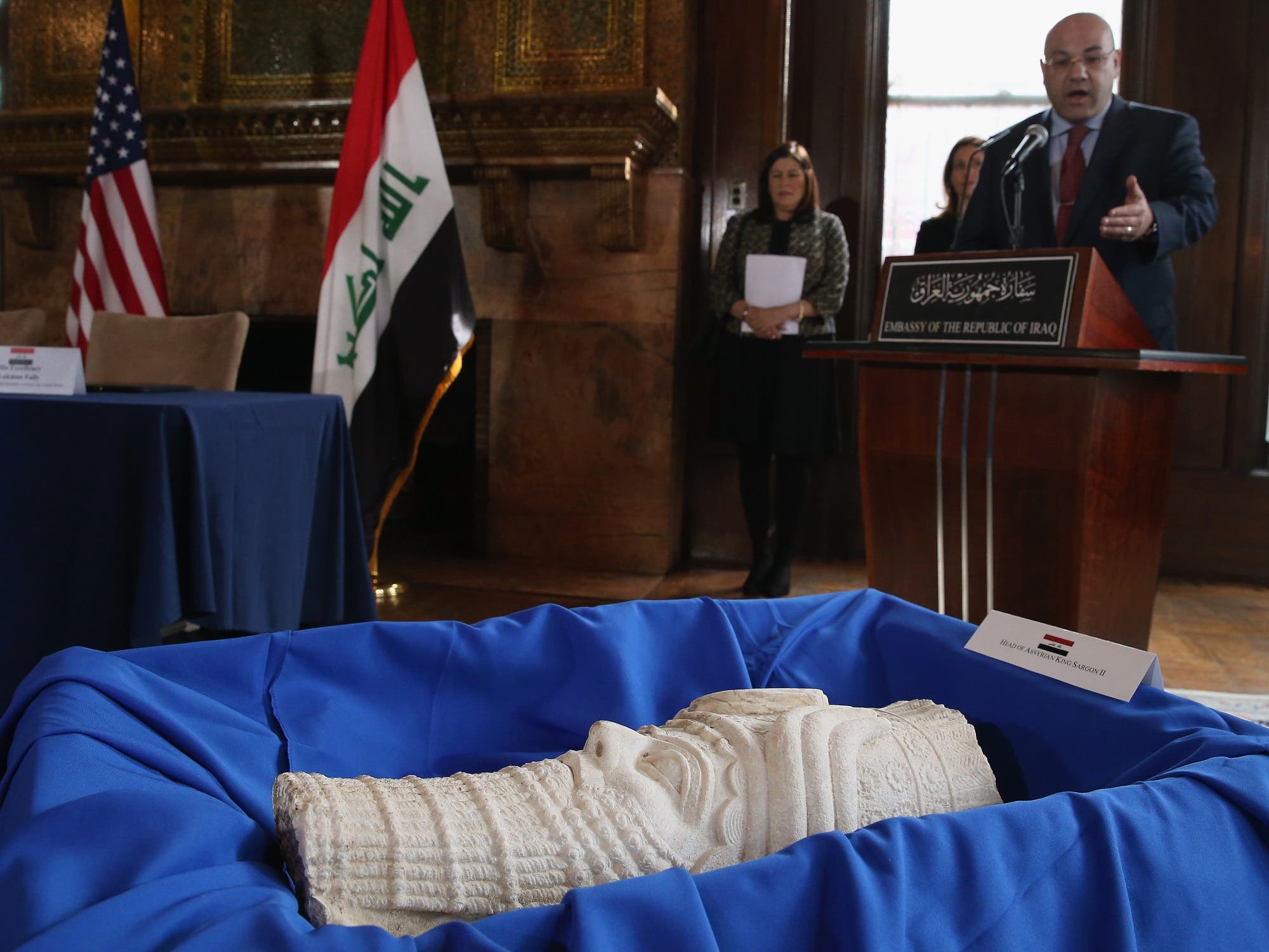 Iraqi Ambassador to the US Lukman Faily speaks in front of a sculpture of the head of Assyrian King Sargon II on March 16, 2015 in Washington, DC. (AFP)