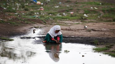 A girl plays near a rain water at a camp for internally displaced people near Sanaa, Yemen, August 10, 2016. REUTERS/Khaled Abdullah