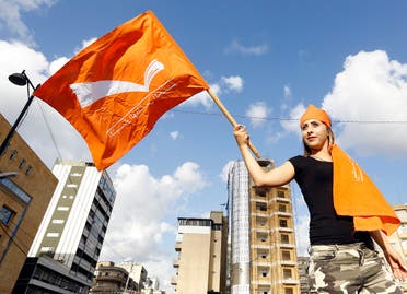 A Lebanese woman holds a Free Patriotic Movement party flag as supporters take to the streets in Jdeideh, on the northern outskirts of the capital Beirut. (AFP)