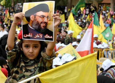 A child holds a picture of Hezbollah leader Hassan Nasrallah during election rallies a few days before the general election in Baalbeck. (Reuters)