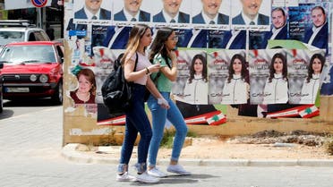 Girls walk past pictures of Lebanese parliament candidates in Beirut. (Reuters)