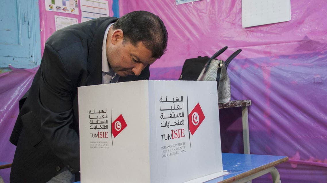 A Tunisian policeman dressed in civilian clothing casts his vote during municipal elections at a polling station for the police and military in Tunis, Sunday, April 29, 2018. (AP)