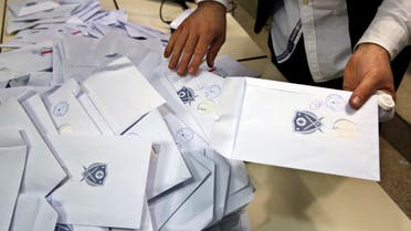 An election official counts ballots shortly after the polling stations closed, in Beirut, Lebanon, Sunday, May 6, 2018. (AP)