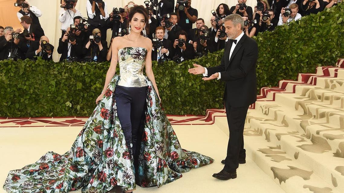 George Clooney (L) and Amal Clooney attend the Heavenly Bodies: Fashion & The Catholic Imagination Costume Institute Gala at The Metropolitan Museum. (AFP)