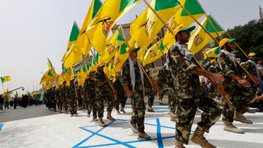 Members of Kata’ib Hezbollah wave party’s flags during a parade marking the annual Quds Day, or Jerusalem Day in Baghdad on July 25, 2014. (Reuters)