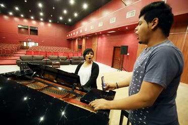 Kuwaiti opera singer Amani Hajji (L), sings with one of her students at the Higher Institute for Musical Arts in Kuwait City. (AFP)