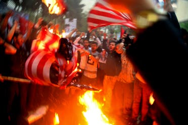 Iranian demonstrators burn representations of the US flag in front of the former US Embassy in Tehran on May 9, 2018. (AP)