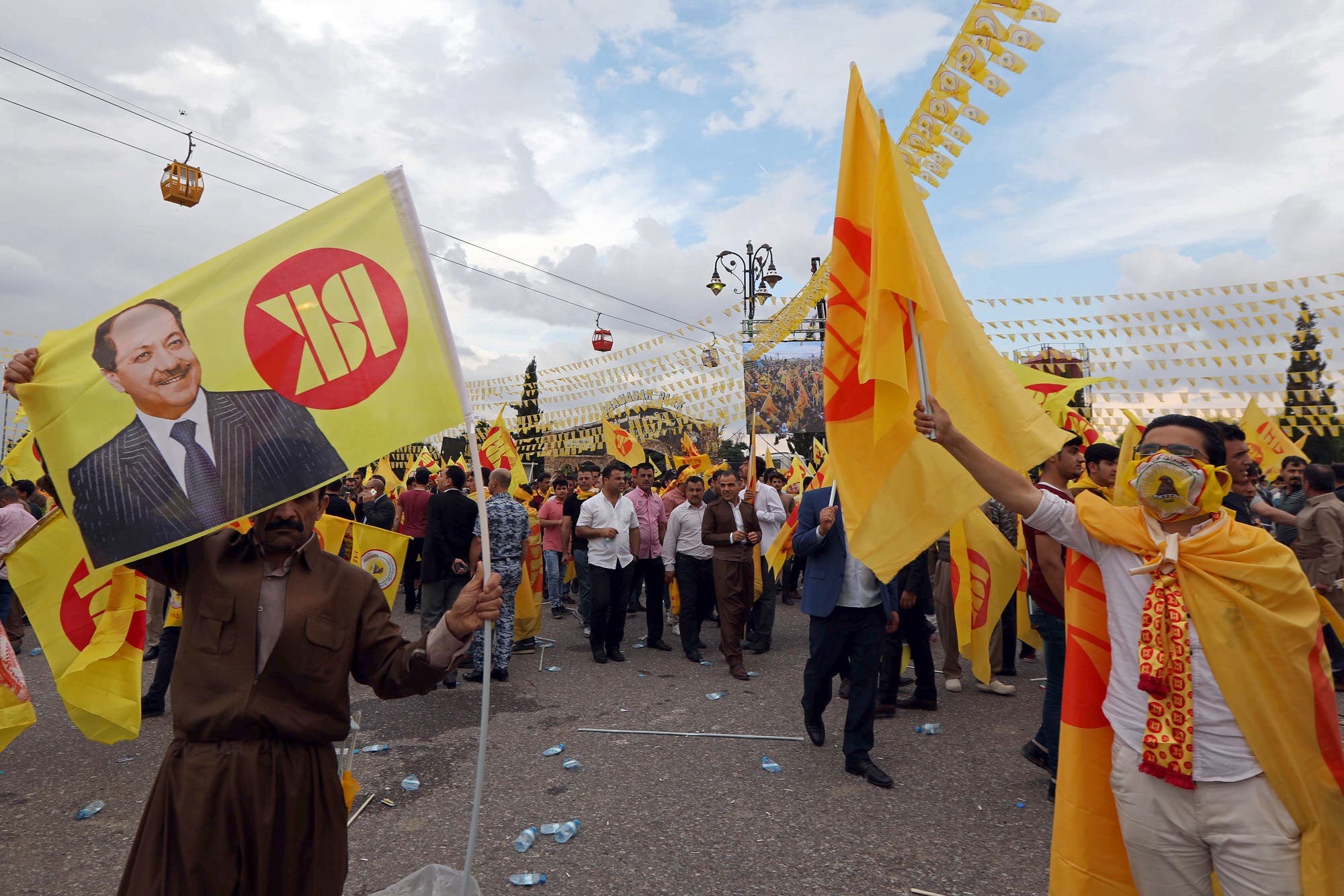 Iraqi Kurds wave flags as they attend an electoral rally for the Kurdistan Democratic Party (KDP) in Erbil on May 10, 2018. (AFP)
