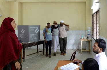 An Indian voter is helped after casting his ballot in the Karnataka Legislative Assembly Elections at a polling station in Bangalore. (AFP)