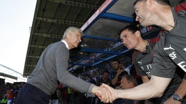 Arsenal’s French manager Arsene Wenger shakes hands with his staff during the English Premier League football match against Huddersfield Townon May 13, 2018. (AFP)